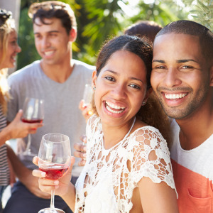 happy couple with friends and wine glasses