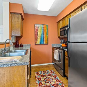 stainless appliances in a kitchen with wood flooring
